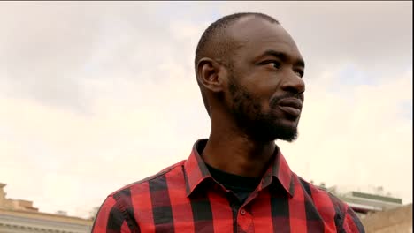 handsome-young-black-man-looking-around--outdoor