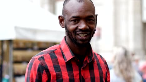 Portrait-of-smiling-black--young-man-in-the-street