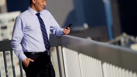 Portrait-of-Asian-American-businessman-using-touchscreen-technology