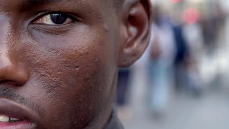 young-black-immigrant-staring-at-camera--half-face--outdoor--slow-motion
