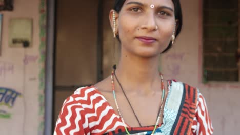 Close-up-of-beautiful-Indian-lady-in-traditional-dress-looks-and-points-at-camera-thumbs-up-best-of-luck-be-good-finger-leader-command-select-face-approves-hand-gesture-smiles-happy-focus-shift