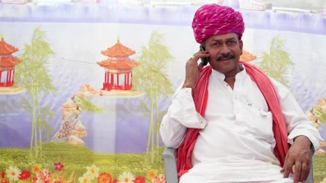 MS-of-Indian-man-seated-and-talking-on-the-phone-with-traditional-clothes