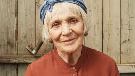 Elderly-Woman-Posing-against-Wooden-Wall