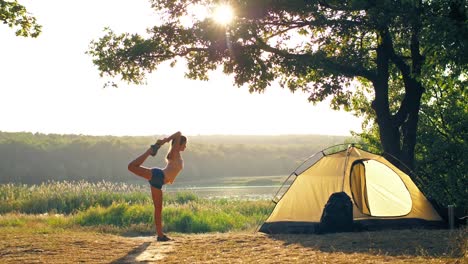 Woman-doing-yoga-in-a-front-of-tent