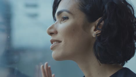 Close-up-Portrait-of-the-Beautiful-Young-Hispanic-Woman-Looking-out-of-the-Window-in-Wonder.