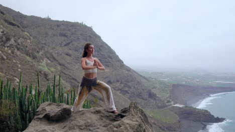 Young-woman-is-practicing-yoga-at-mountain-lake.