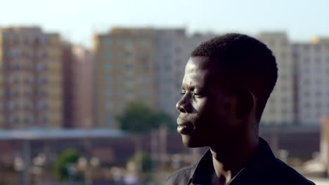 Thoughtful-young-african-man-alone-thinking-contemplating-the-city