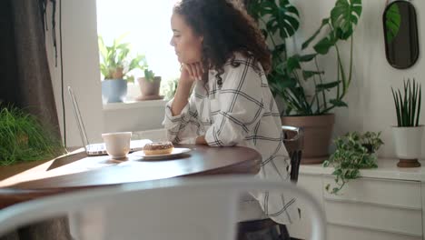 Charming-young-woman-typing-on-laptop-computer-at-home.