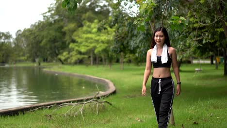 Pretty-female-wearing-sportswear-walking-exercise-pass-swamp-in-park