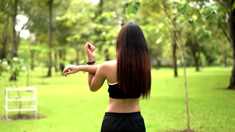 Young-female-runner-stretching-muscles-in-nature-park