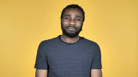 Casual-African-Man-Gesturing-Thumbs-Up-Isolated-on-Yellow-Background