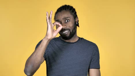 Okay-Sign-by-Casual-African-Man-Isolated-on-Yellow-Background