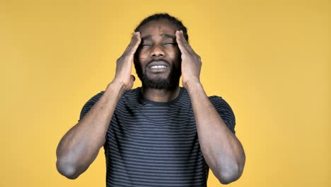 Casual-African-Man-with-Headache-Isolated-on-Yellow-Background