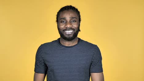 Flying-Kiss-by-Casual-African-Man-Isolated-on-Yellow-Background