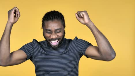 Happy-Casual-African-Man-Dancing-Isolated-on-Yellow-Background