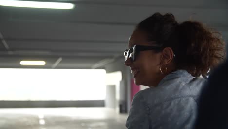 Smiling-Woman-Having-Fun-In-Shopping-Cart-At-Parking