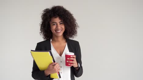 Happy-businesswoman-with-coffee-and-file