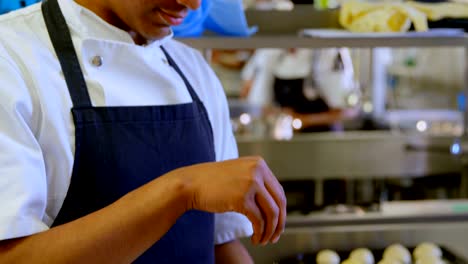 Chef-sprinkling-sugar-on-bowl-in-kitchen-4k