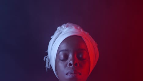 Serene-Black-Woman-in-Headscarf-in-Dark-Studio