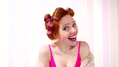 Young-Redhead-Woman-Curlers-In-Hair-Pulling-A-Face
