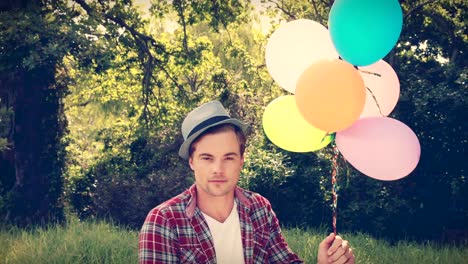 Handsome-hipster-holding-balloons