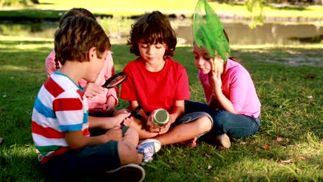 Happy-little-friends-looking-at-jar