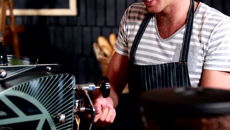 Smiling-waiter-making-cup-of-coffee