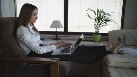 Attractive-woman-buys-online-with-credit-card-and-computer