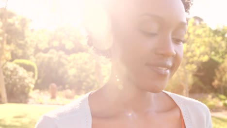 Portrait-of-attractive-woman-is-smiling-in-a-park