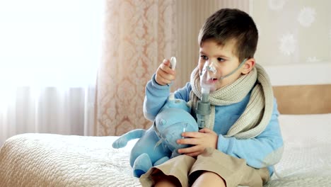 sick-child-breathes-through-nebulizer,-baby-does-inhalation,-boy-with-an-oxygen-mask-on-his-face,-treatment-at-home,-medical-procedure,-Nebulizer