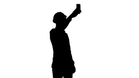 Trabajador-de-la-construcción-Silhouette-usando-el-teléfono-para-tomar-selfies