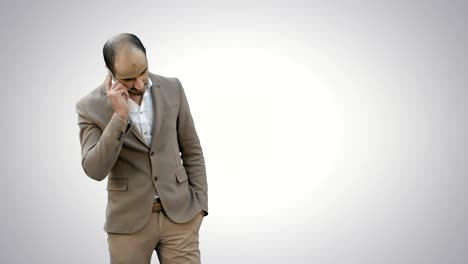 Arab-business-man-talking-on-the-mobile-phone-on-white-background