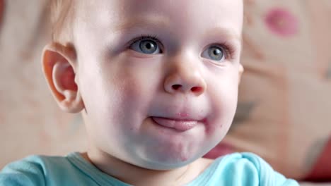 An-attractive-boy-2-years-old-eats-a-red-beet-salad.-The-face-is-smeared-with-porridge.-Sits-on-the-table.-Close-up