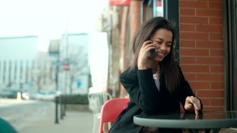 Portrait-of-young-African-American-woman-using-phone,-outdoors.