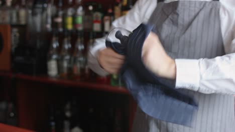 Bartender-wiping-glass-with-rag