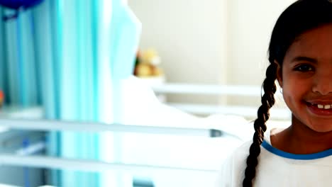 Girl-smiling-at-camera-in-hospital