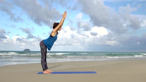 Woman-practicing-yoga-on-the-beach-at-sunset.-Exercises-calmness-and-harmony.