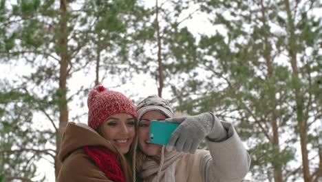 Happy-Women-Taking-Picture-at-Winter-Vacation