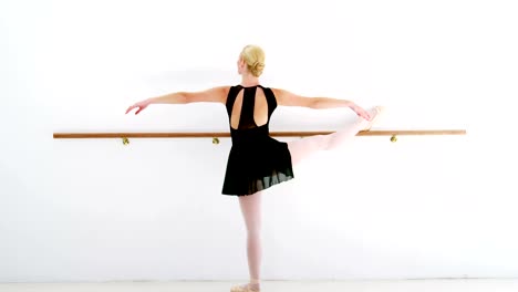 Ballerina-practicing-ballet-dance-at-barre