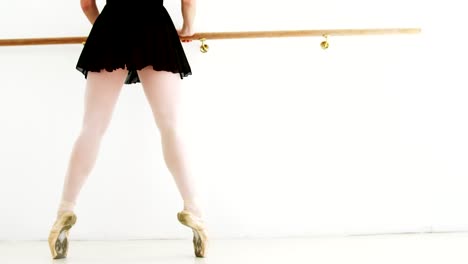 Ballerina-practicing-ballet-dance-at-barre