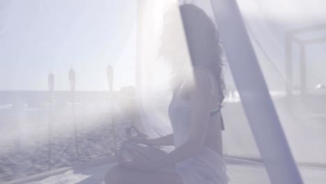 women-meditating-on-embankment-beach,-summer-vacation-in-at-resort,-girl-doing-yoga-on-beach,-meditation-on-coast