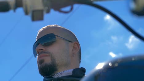 Male-biker-wearing-sunglasses-and-leather-jacket.