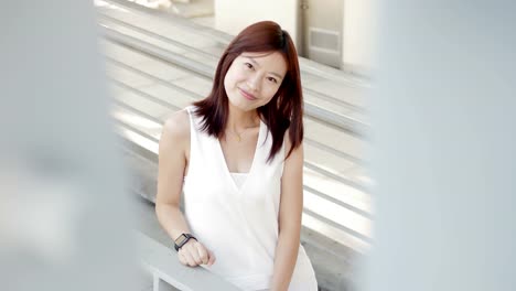 Attractive-Chinese-Woman-in-Urban-Environment.-Looking-at-the-Camera-with-Dark-Eyes-and-Dyed-Hair.