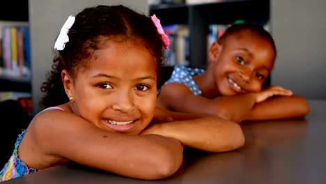 Portrait-of-happy-schoolgirls-leaning-on-table-4k