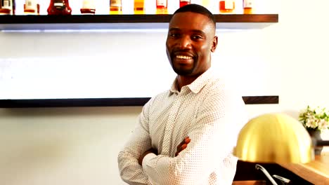 Portrait-of-man-standing-with-arms-crossed-in-restaurant