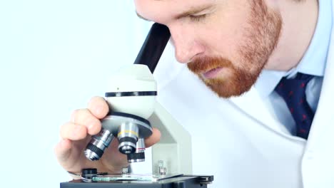 Male-Chemist-Scientific-Reseacher-using-Microscope-in-Laboratory