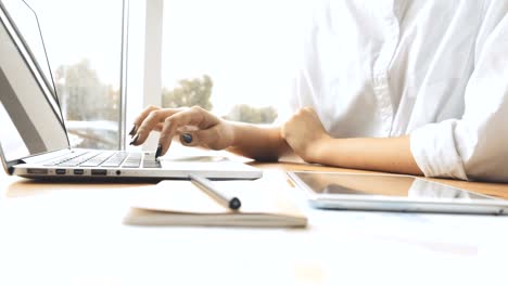 Woman-using-laptop-and-tablet