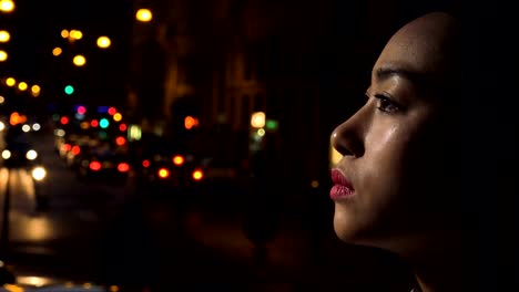 Sad,-depressed-Chinese-young-woman's-profile-cries,-night-city-in-background
