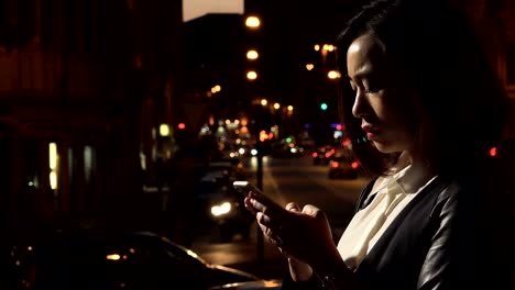 Profile-of-sad-young-Chinese-woman-crying,holding-the-smartphone-on-her-chest