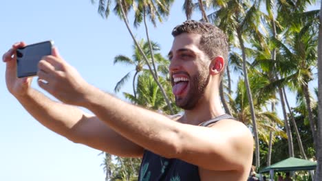 Young-Man-taking-a-selfie-in-Forte-Beach,-Brazil